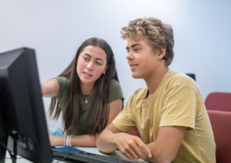 two youth at computer