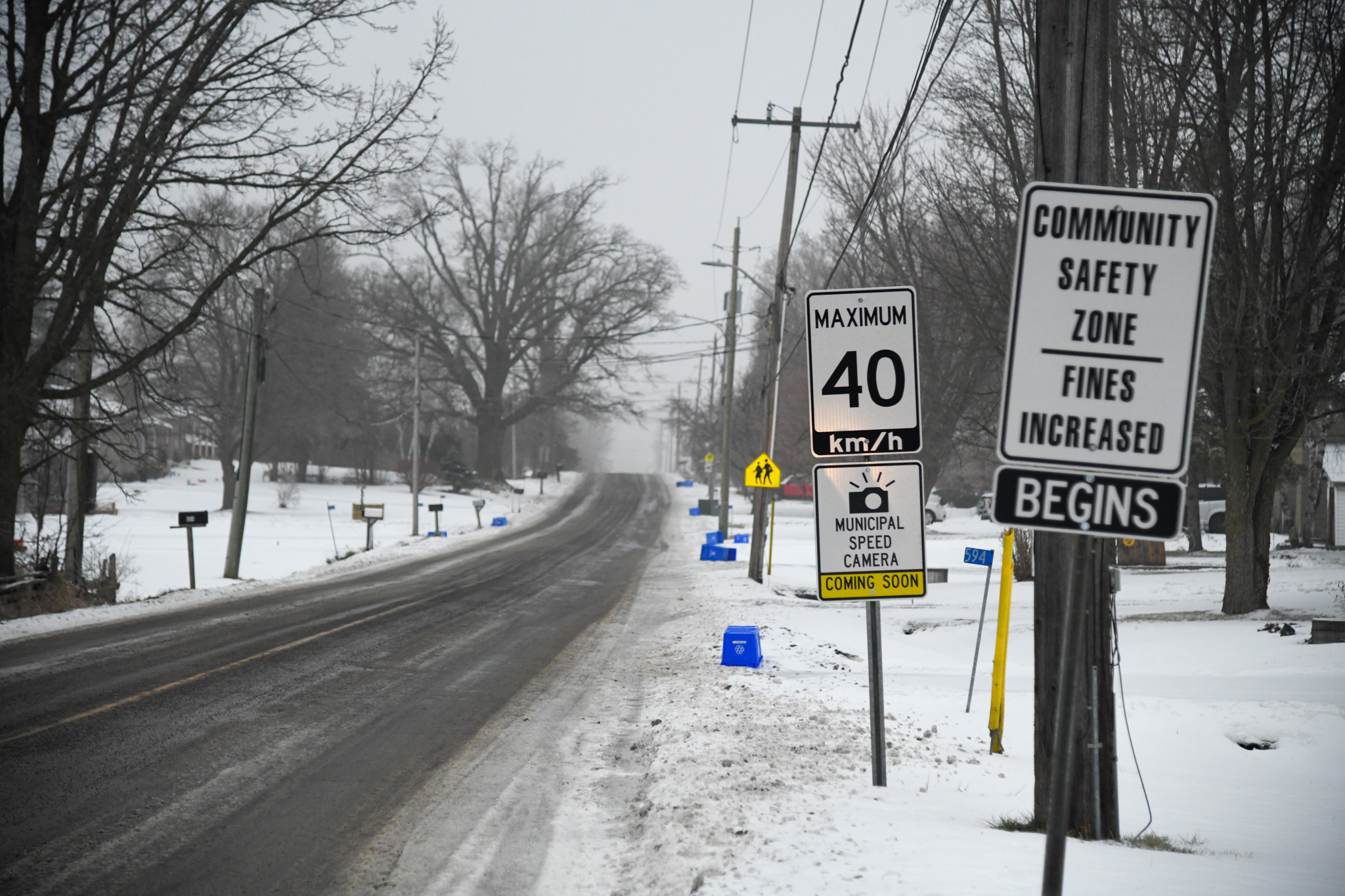 Street in winter time with sign saying Municipal Speed Camera coming soon