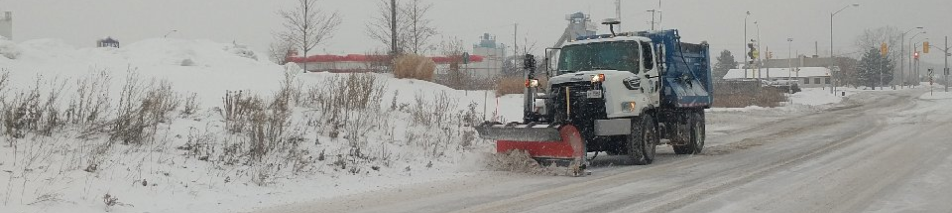 Photo of a snowplow on a snowy road